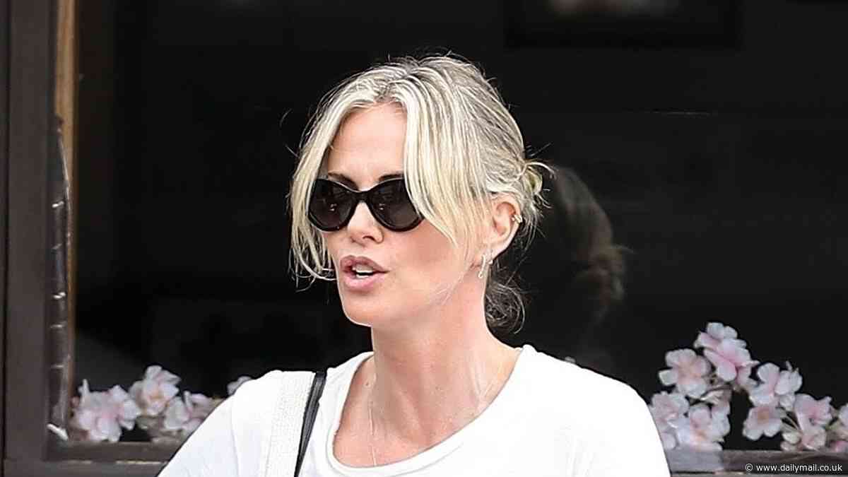 Charlize Theron cuts a casual figure in a T-shirt and patterned jeans after enjoying sushi with pals in Los Angeles