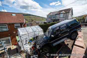 Huge 4x4 'dangles' at top of garden after rolling away from house