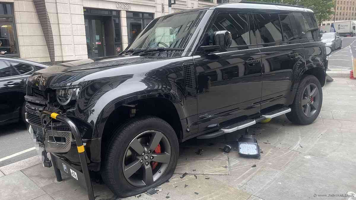 'Can't park there mate': Land Rover drives OVER lamppost and into bike stand in central London