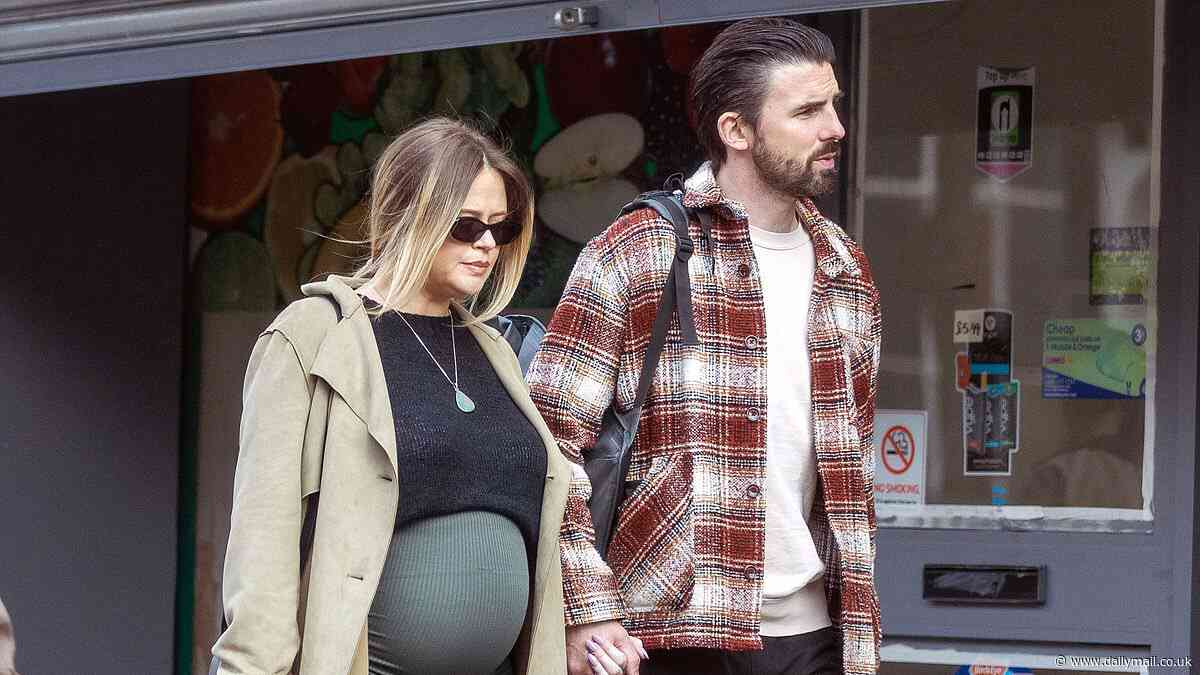 Heavily pregnant Emily Atack dresses her baby bump in a khaki maxi skirt while on a stroll with boyfriend Alistair Garner ahead of her due date