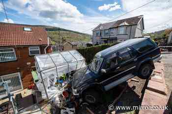 Couple fear for their lives as crashed 4x4 left dangling over their garden for days