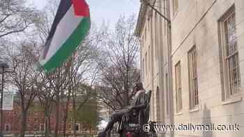 Palestinian flag is raised over Harvard statue taking the place of the Stars and Stripes that typically flies proudly above founder's memorial
