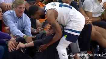 Timberwolves coach Chris Finch is injured by his own player after brutal collision with Mike Conley... as concerned players surround 54-year-old before he limps away late on in playoff win vs the Suns