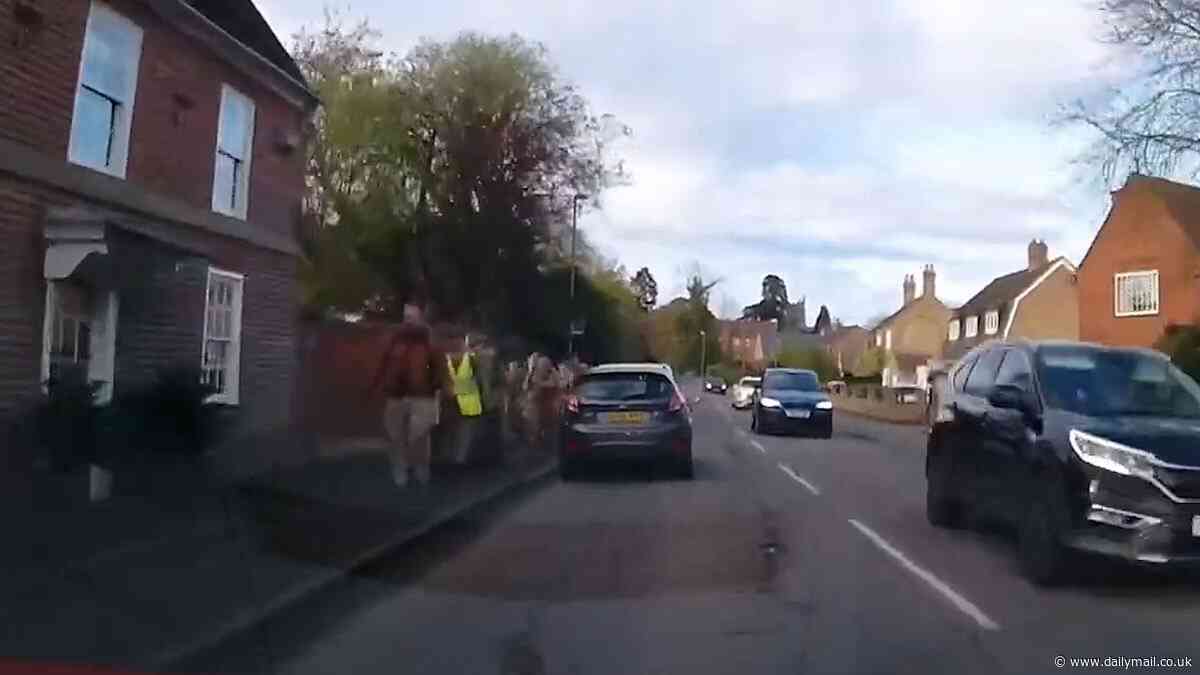 Shocking moment drink-driver nearly swerves into a group of teenage cadets after downing a bottle of wine