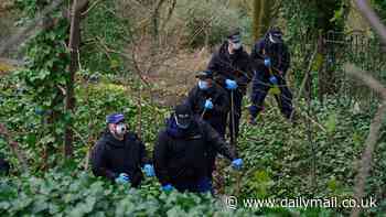 Two men are charged in headless torso probe as police find more human remains scattered near railway lines