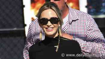 Emily Blunt keeps it chic in black Louis Vuitton turtleneck as she waves at fans while arriving at Jimmy Kimmel Live