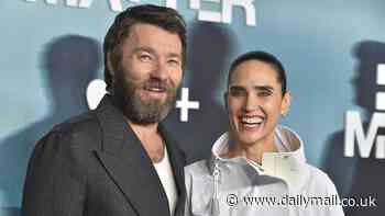 Jennifer Connelly shows off her toned legs in a tiny white mini skirt as she cuddles up to Aussie actor Joel Edgerton at Dark Matter premiere in LA