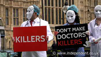 Masked medics join anti-euthanasia protest outside parliament