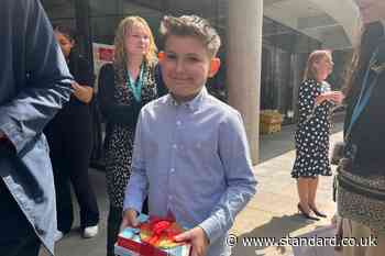 Cancer patient Ellis, 11, receives books and chocolate coin from King and Queen