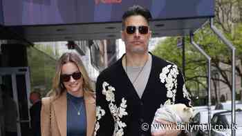 Joe Manganiello, 47, and girlfriend Caitlin O'Connor, 34, hold hands as they stroll in New York City