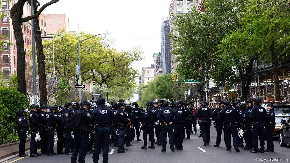 Columbia braces as HUNDREDS of NYPD riot cops surround pro-Palestine encampment as university issues 'shelter in place' and protesters link arms screaming 'we will not be moved'