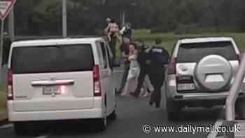 Manunda road rampage: Wild moment driver with a knife is pulled from her car and thrown to the ground