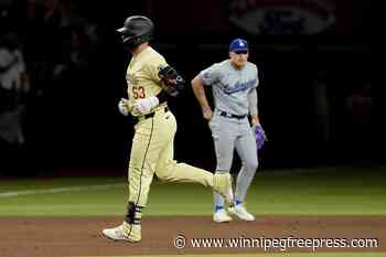 Bee-lieve: Walker’s homer in 10th lifts Diamondbacks over Dodgers 4-3 after delay for bee swarm