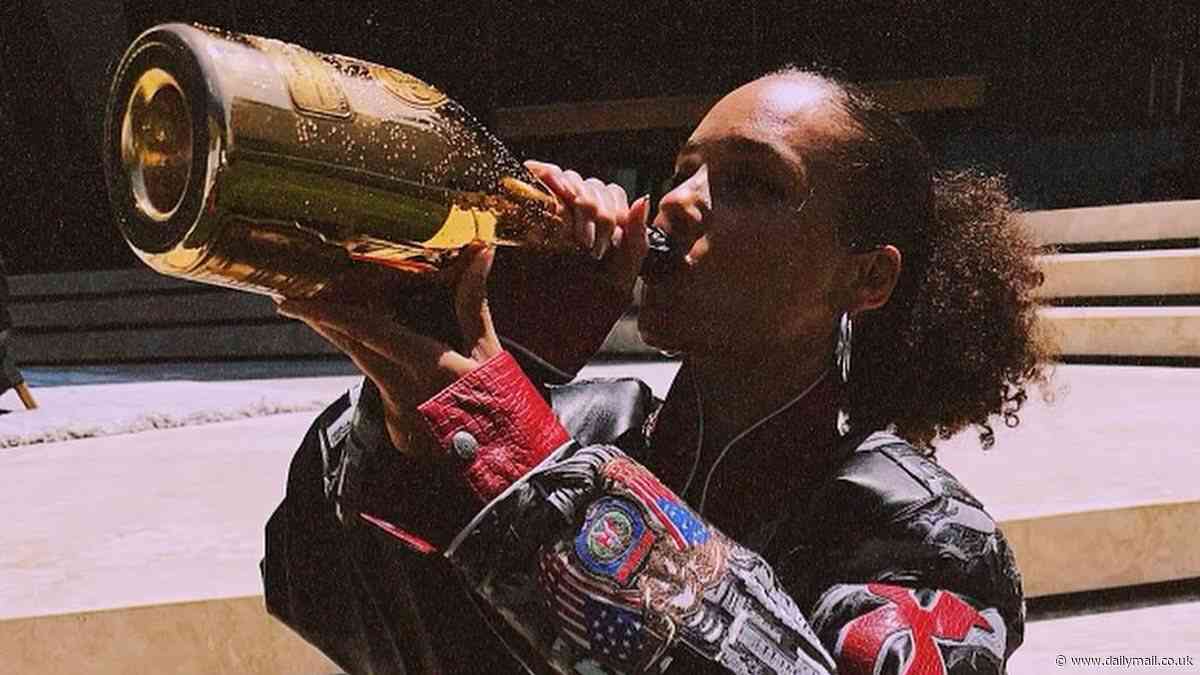Alicia Keys pops a bottle of champagne in celebration after receiving an incredible 13 Tony Award nominations for her Broadway musical Hell's Kitchen