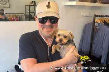 Ricky Gervais seen in Hampstead cuddling rescue dog