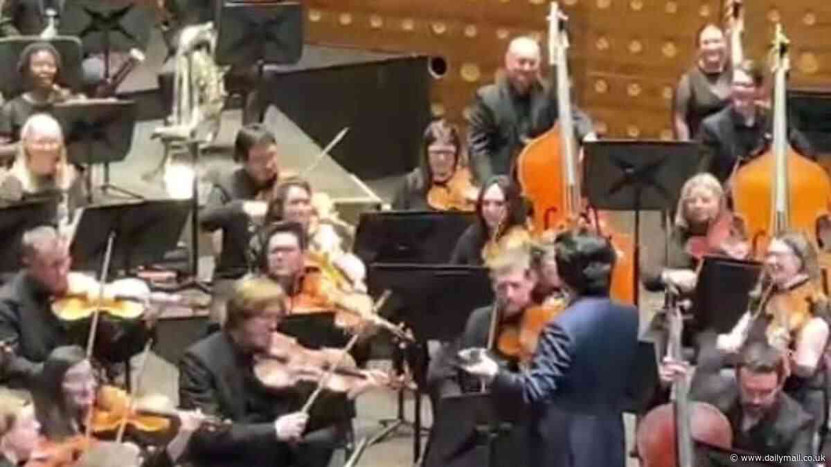 Row breaks out as orchestra bosses say young audience members CAN film concerts on their phones - after singer stopped show to complain about the practice