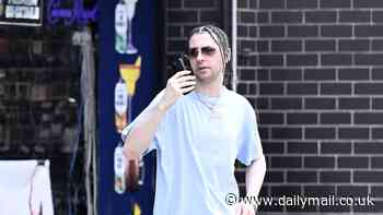 Cyndi Lauper's troubled son 'Dex' is seen berating someone on the phone after taking chauffered SUV to pharmacy from his $7k apartment