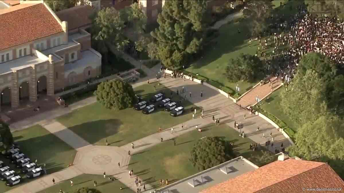 UCLA pro-Palestine protestors brace for clashes with cops for the second night with LAPD officers dressed in riot gear flooding the campus - as colleges across the nation crack down on campus encampments