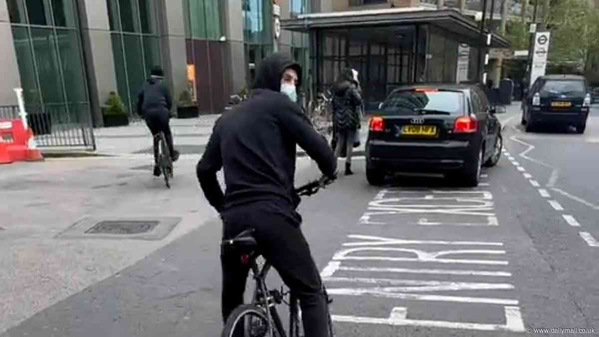 Shocking moment hooded thug steals bike in London's Canada Water as he hurls abuse at the shocked bystander filming him