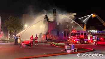 Flames ravage Windsor's abandoned 'rainbow house' on Ouellette in overnight fire
