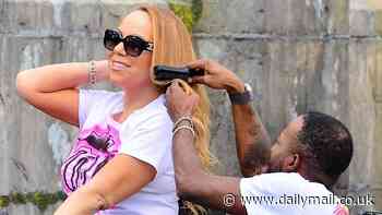 Mariah Carey gets her hair touched up on a ROLLERCOASTER as stylist brushes through her tresses at Universal Islands of Adventure