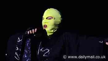 Madonna dons balaclava mask onstage during rehearsal for her free concert in Rio de Janeiro, Brazil ... as her children Mercy James and David Banda are seen in South American locale