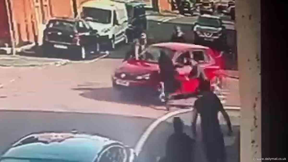 Shocking moment car ploughs into four people outside a polling station: Two teenagers are arrested as woman, 43, is left in hospital
