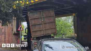 Lorry wedged under railway bridge after crash