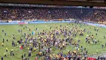 Awkward moment Roda JC fans invaded the pitch after thinking they were promoted to the Eredivisie.... only for rivals Groningen to score a 95th-minute equaliser to deny them a spot in the Dutch top flight