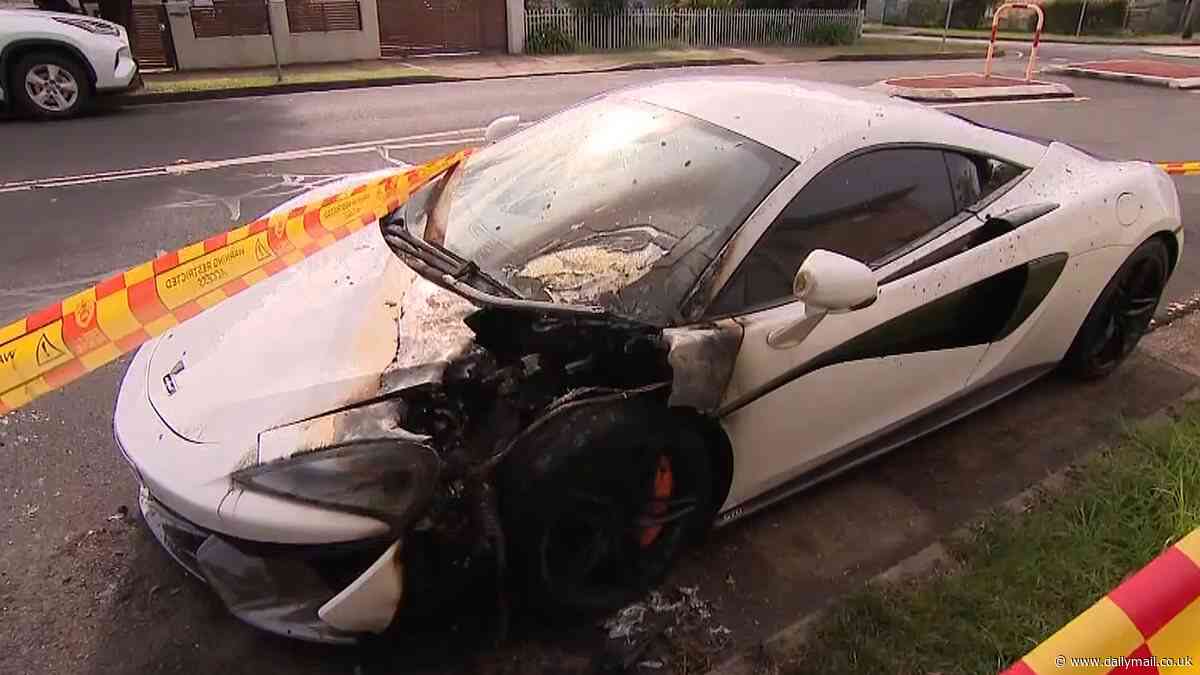 Jaw-dropping moment hooded figure uses a pizza box to light a fire that destroyed a $350,000 McLaren