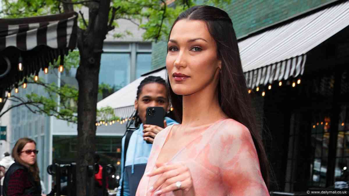 Bella Hadid exudes retro glam in flowy pink dress with a plunging neckline while stepping out in New York City