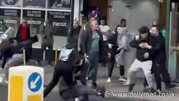 Moment huge street brawl explodes between groups of men, spilling out into the road