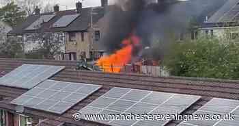 Dramatic footage shows fire burning at house in Stockport before emergency services swarm area