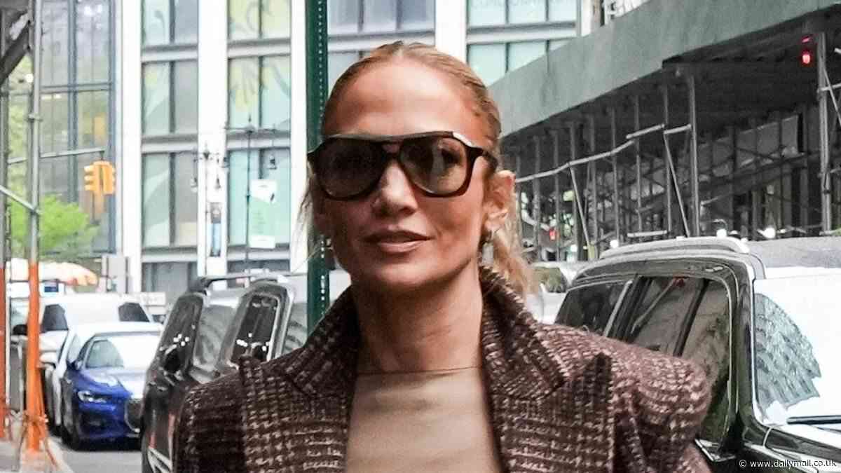 Jennifer Lopez looks stylish in tan column dress as she heads to her hotel in New York City one day ahead of the Met Gala