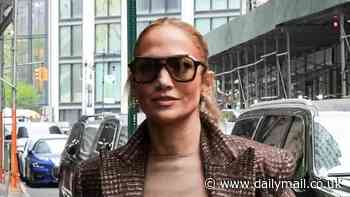 Jennifer Lopez looks stylish in tan column dress as she heads to her hotel in New York City one day ahead of the Met Gala