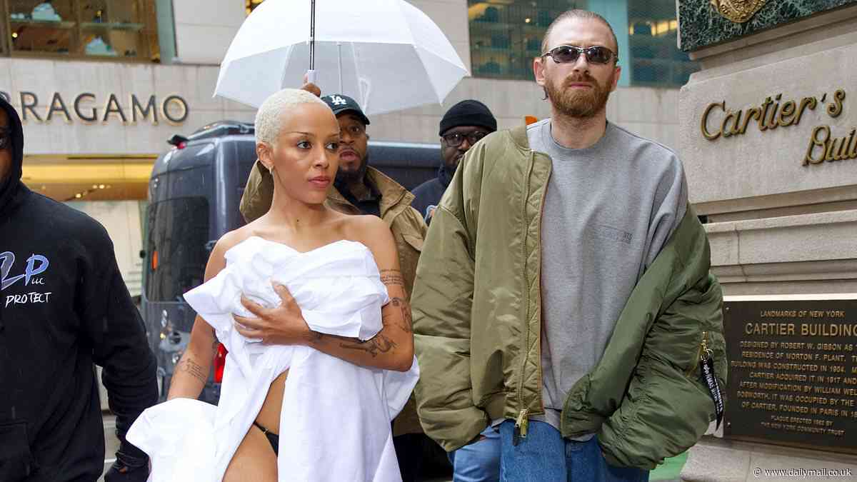 Doja Cat's just rolled out of bed! Rapper shocks by wearing just linen SHEET and thong for NYC shopping spree... before changing into racy leather dress for pre-Met Gala party