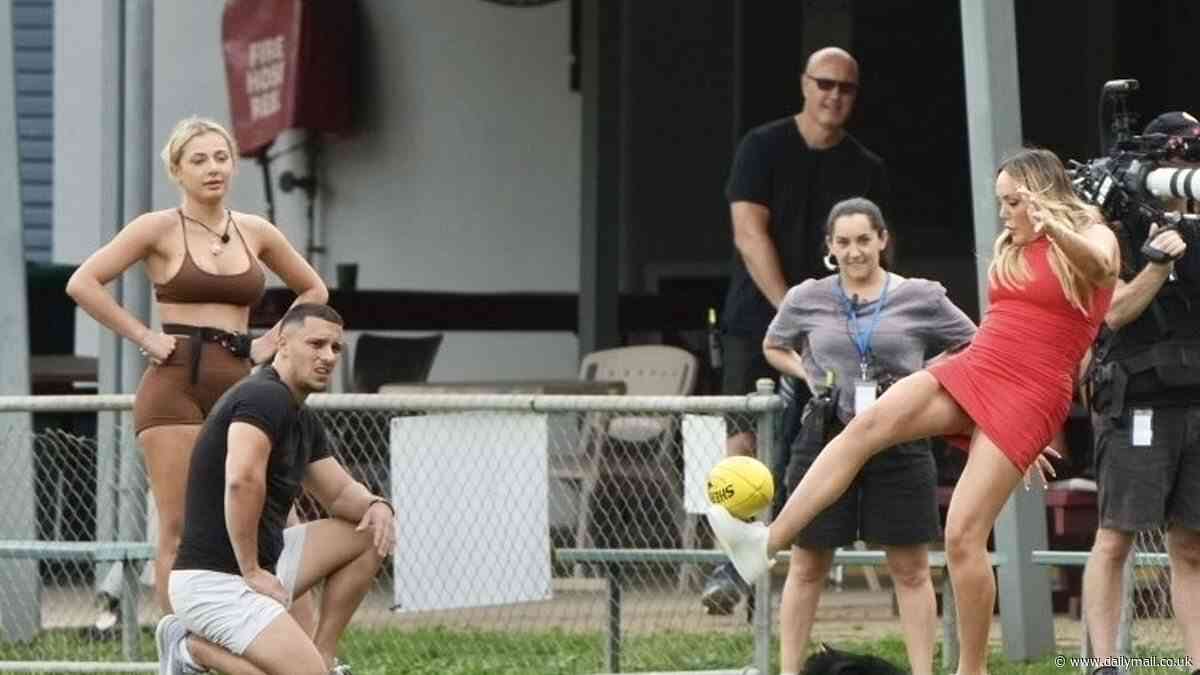 Charlotte Crosby is leggy in a red mini dress as she  attempts to play AFL while filming Aussie Shore in Cairns