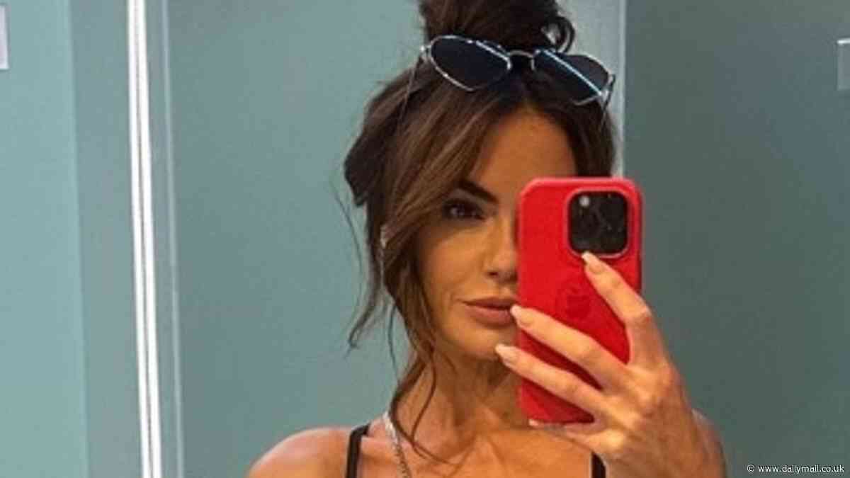 Jennifer Metcalfe shows off her slim figure in a skimpy black bikini as she poses for a selfie during lavish holiday