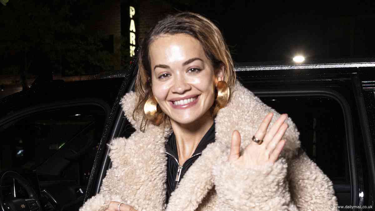 Rita Ora beams as she returns to her New York hotel in skintight suede trousers ahead of the Met Gala