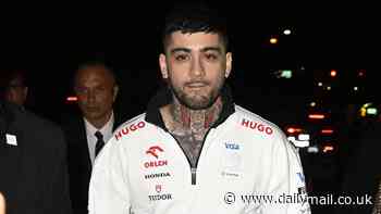 Zayn Malik cuts a casual figure as he watches Lando Norris' victory in the Miami Grand Prix after sending fans into a frenzy by announcing his first EVER solo gig