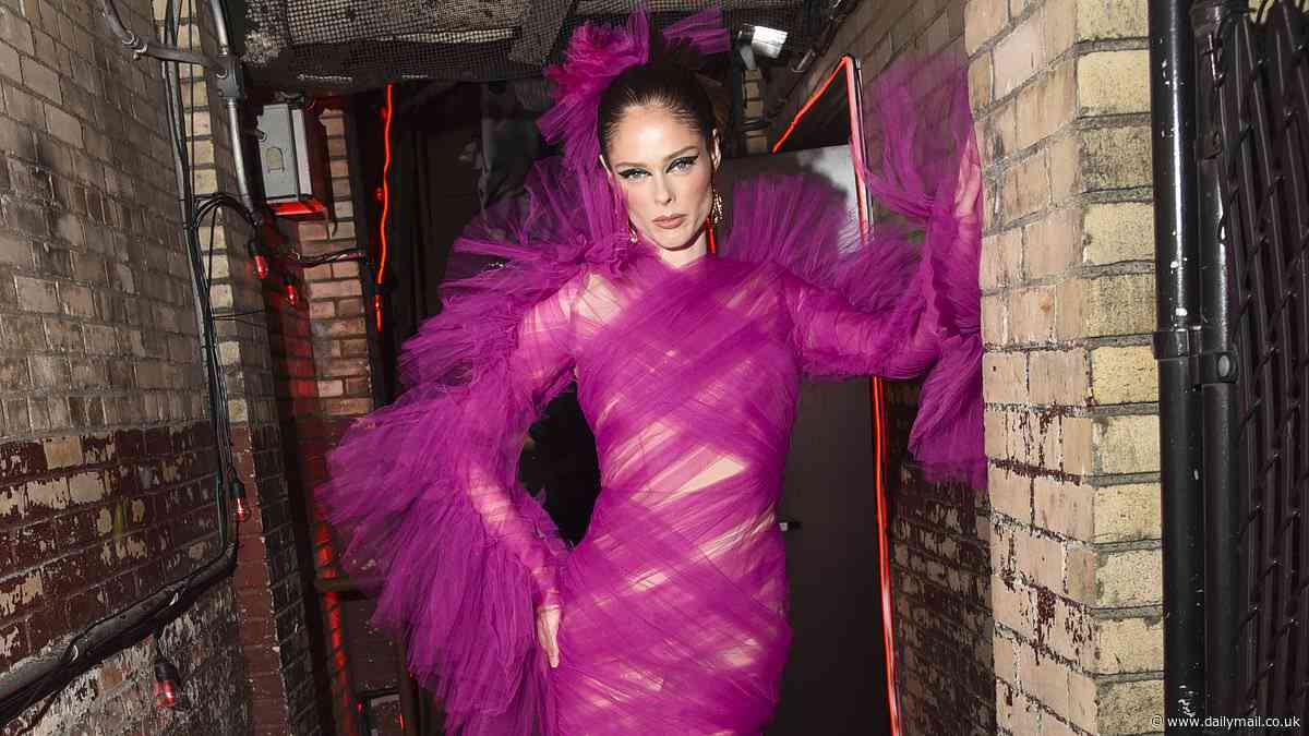 Coco Rocha poses up a storm in a magenta pink chiffon gown at the Mulberry bar at Met Gala afterparty