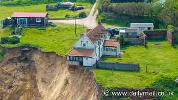 Living literally on the edge! Drone footage shows 18th century three-bedroom home on Norfolk coastline perilously close to collapsing as cliff crumbles amid heavy downpours