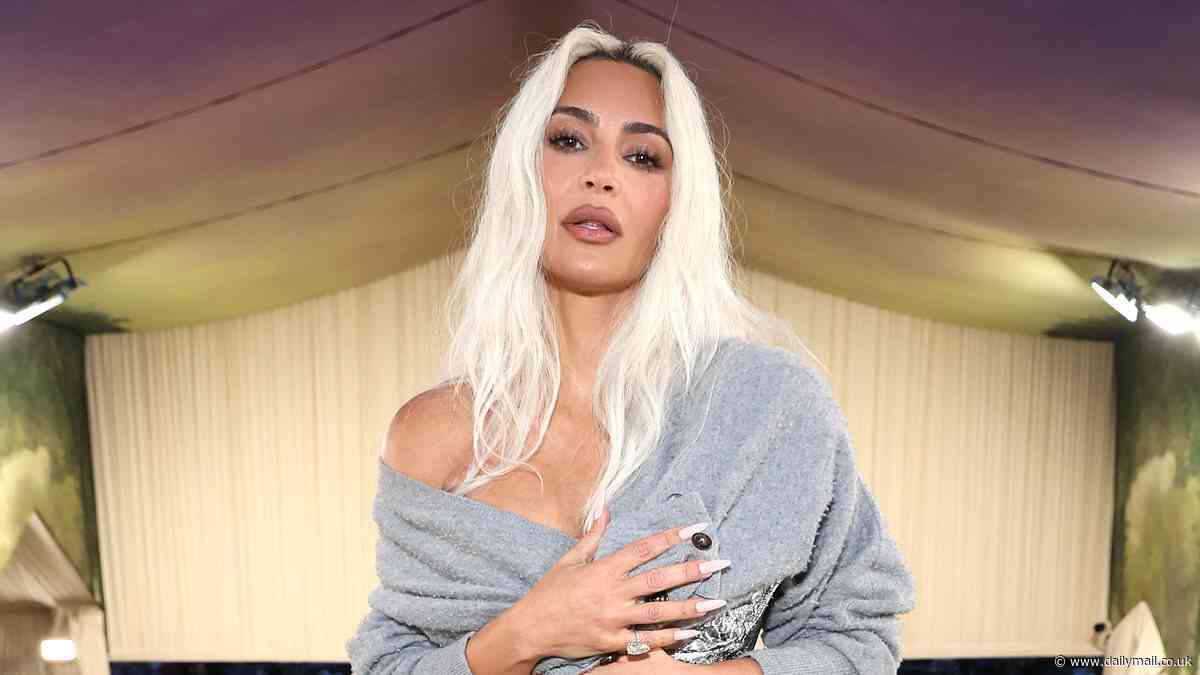 Kim Kardashian explains why she was awkwardly holding a gray sweater over her chest at the Met Gala (and it has to do with a 'wild' night with an ex!)