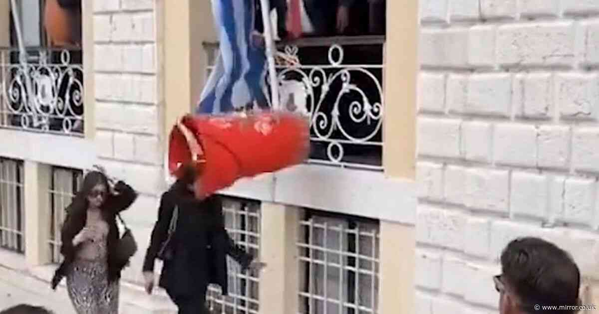 Unfortunate moment enormous clay jug falls on woman's head in Greek tradition gone wrong