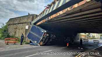 Truck overturns following crash with Bradford railway bridge