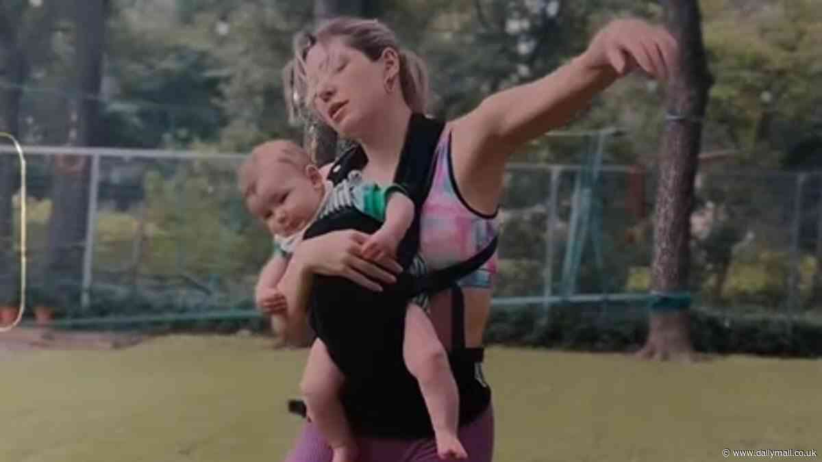 Australian model Ashley Hart does an unusual 'interpretive motherhood' dance with her baby Priest strapped to her chest: 'Magic through my body'