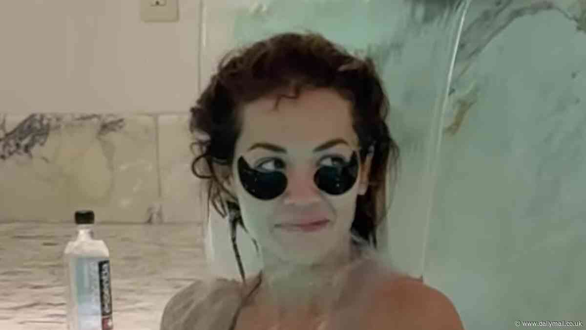 Rita Ora's hangover cure? Bikini-clad singer sports soothing eye patches as she sticks her head under pool fountain at New York spa as she recovers from her Met Gala all-nighter