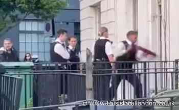 Camden Road: Police use battering ram to break down door