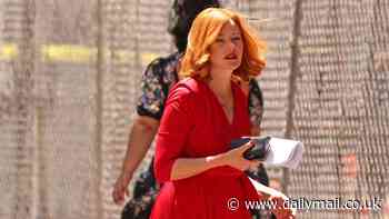 Elizabeth Banks channels Lucille Ball in red hair and dress on the set of DreamQuil with John C Reilly... after sharing image from Press Your Luck