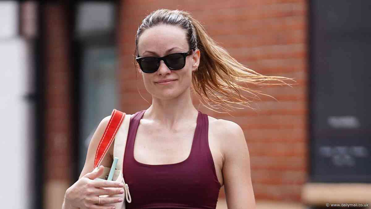 Olivia Wilde bares her washboard abs in burgundy sports bra and leggings as she leaves her daily gym session